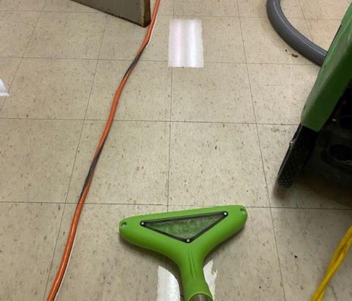 Water on a floor with extractor machine