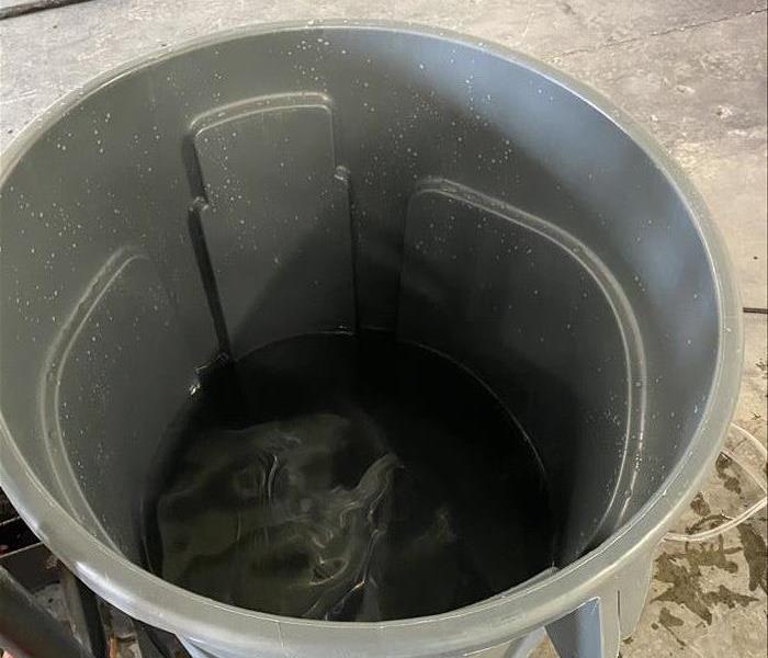 large trash can full of water