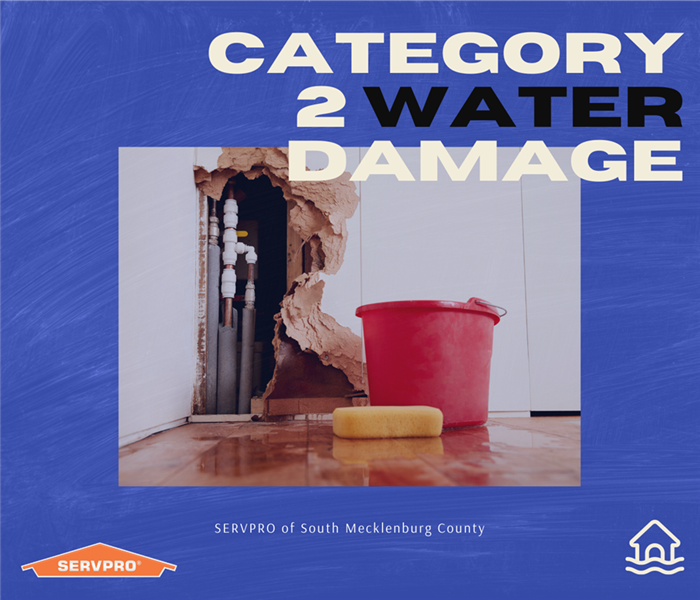 “Category 2 Water Damage” with photo of bucket and sponge and SERVPRO logo 